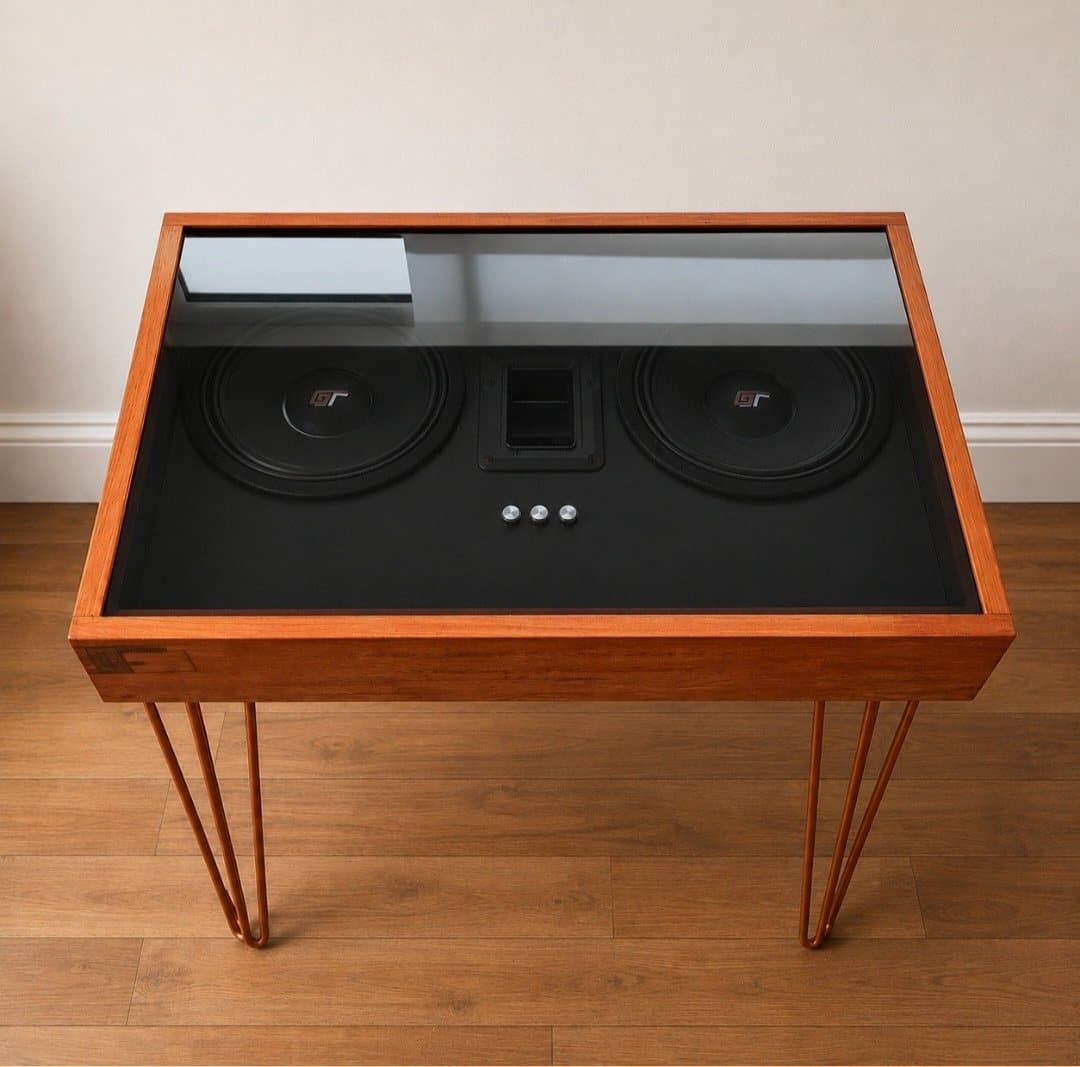 Side table on copper hairpin legs with two drivers and controls under a glass top