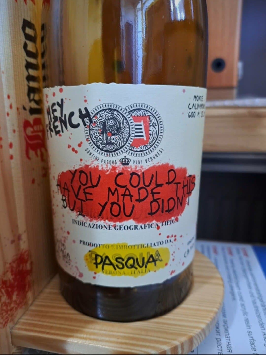 Close up of the bottle label beside the glass front wine box speaker