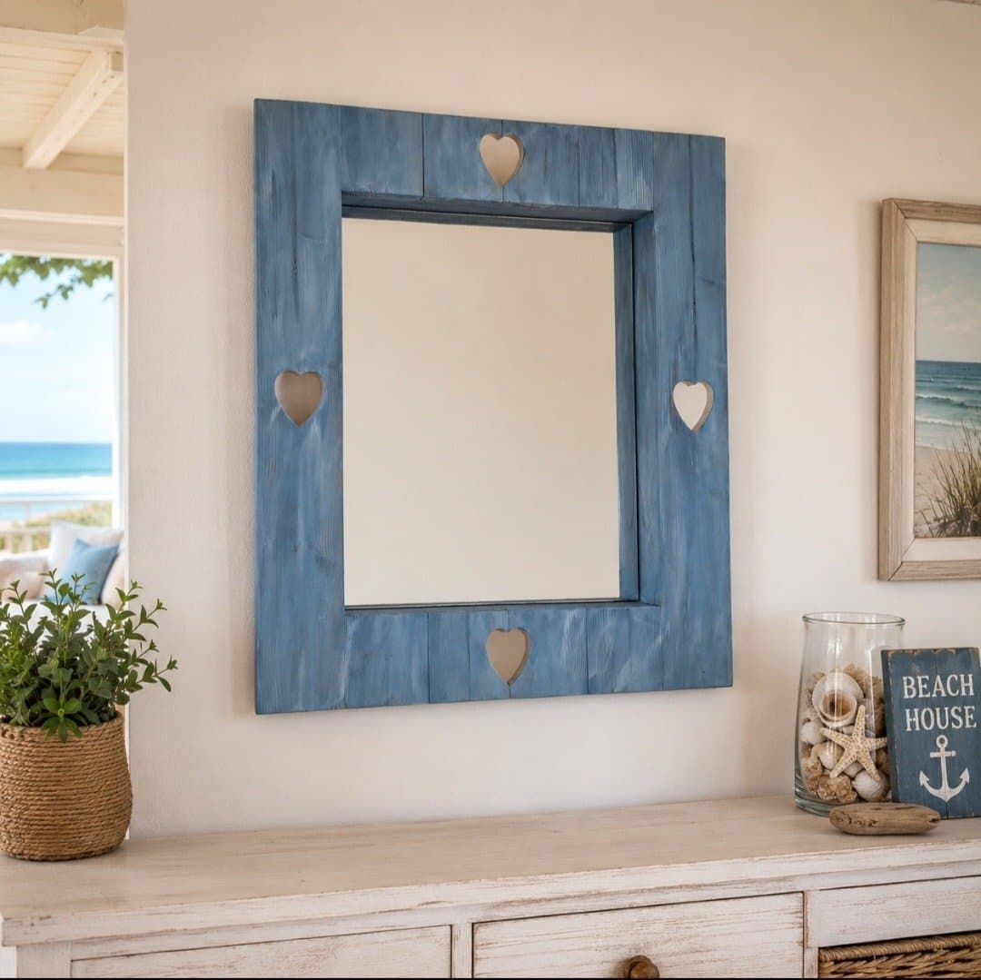 Blue mirror with small hearts in a coastal room